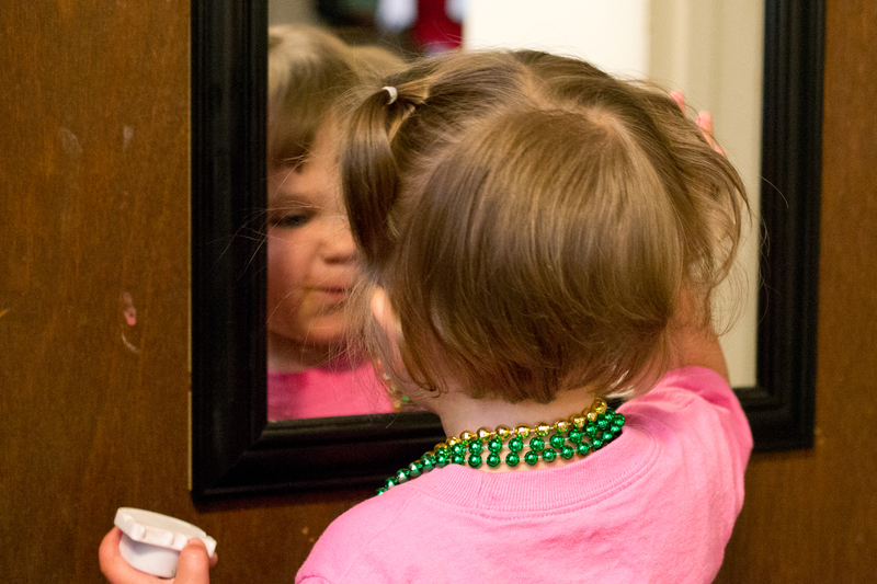 Checking herself out in the mirror