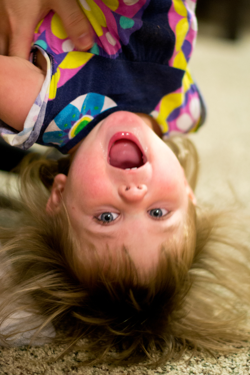 Being held upside down by daddy