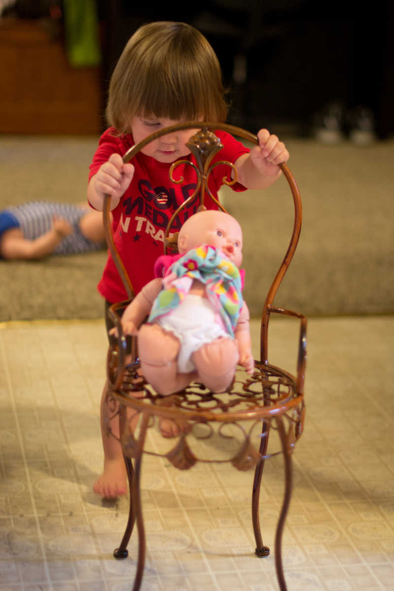 Pushing her baby around in a "stroller"