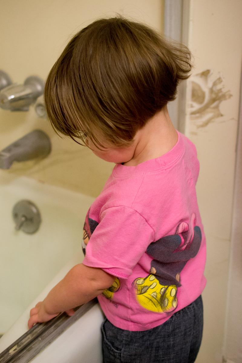 Emily watches as the water drains