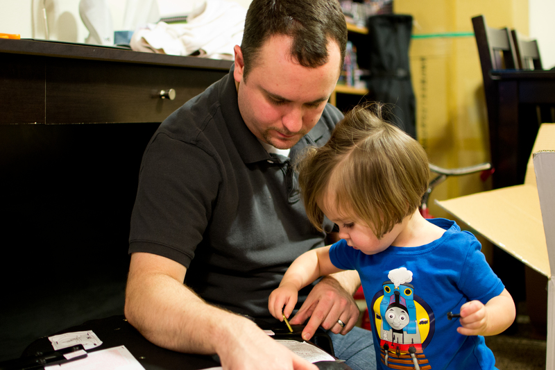 Helping Daddy put together his new chair