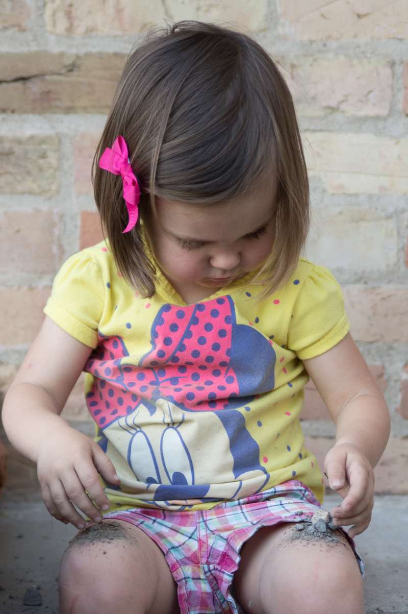 Pouring gravel onto her knees