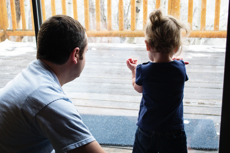 Watching the snow fall from safe inside the warm cabin
