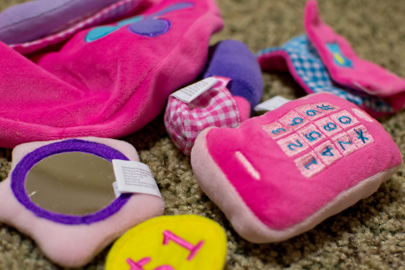 Em got a toy purse filled with all kinds of goodies