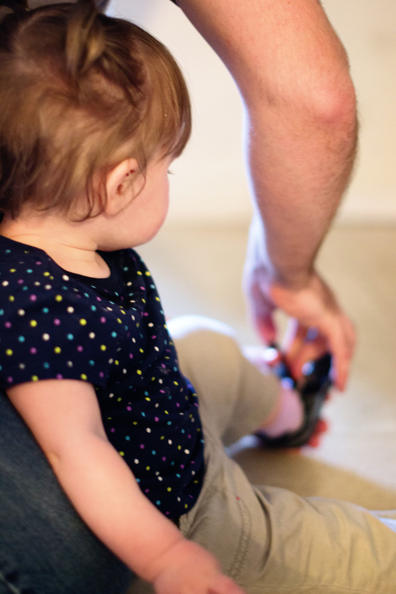 Daddy helps with taking shoes off