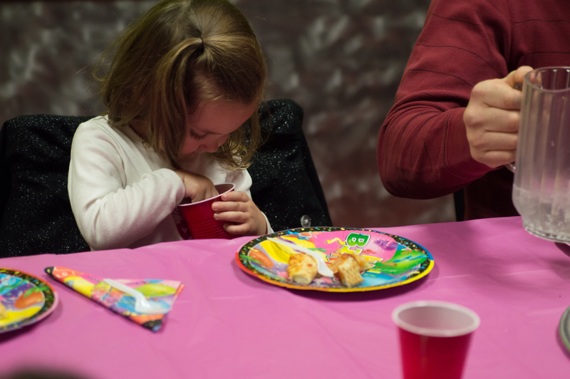 Playing with the ice in her soda