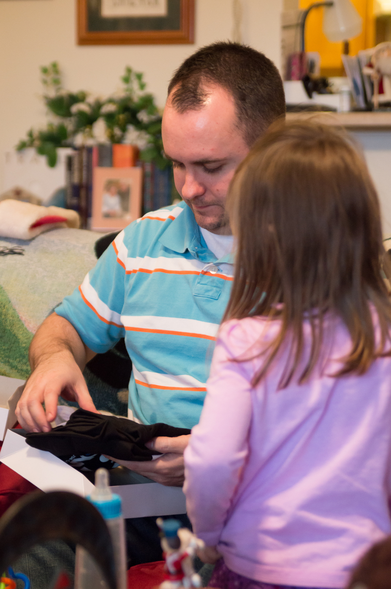 Emily helps Keith open his presents, too